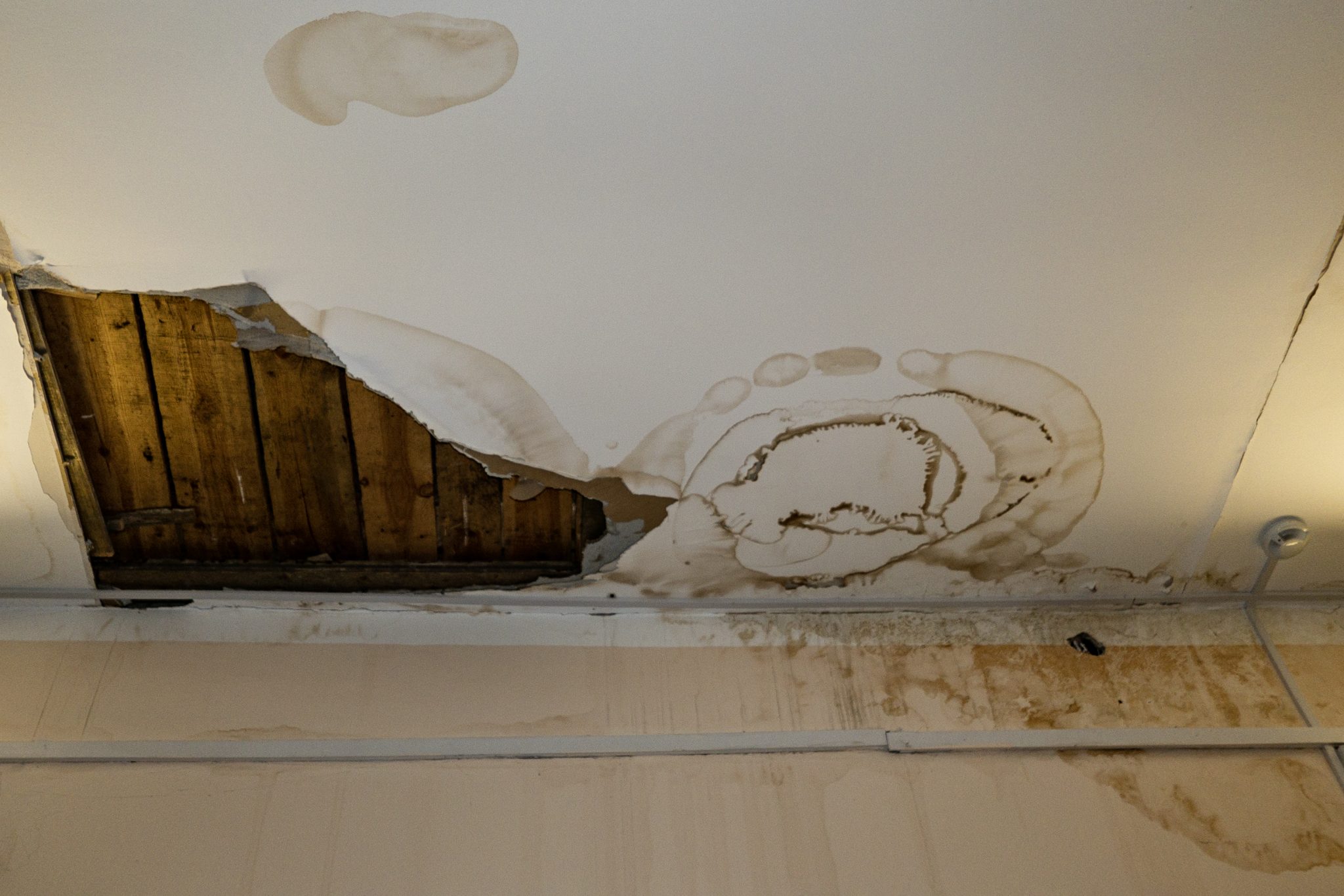 Flooding rainwater, causing damage, peeling paint and mildew.